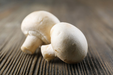 Champignon mushrooms on grey wooden background