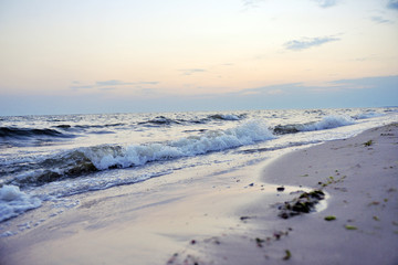 Sea shore, waves and sky at sunset