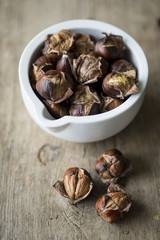 Chestnuts in a small white pot