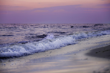 Sea shore, waves and sky at sunset