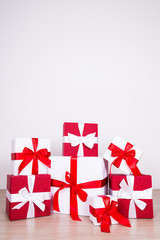 Christmas background - red and white gift boxes on wooden floor