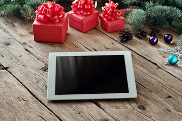 White tablet computer with Christmas gifts