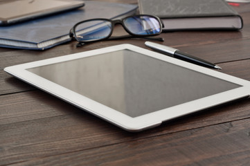 white tablet computer with office objects