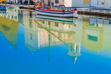 Fototapeta na wymiar Reflection of church and boats on Canal Port