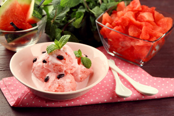 Watermelon ice cream in bowl  on color wooden background