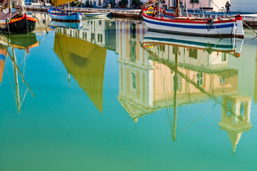 Fototapeta na wymiar Reflection of church and boats on Canal Port