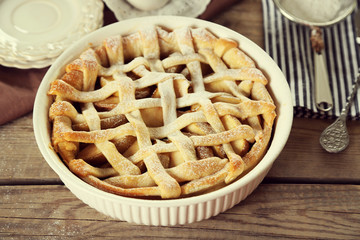 Homemade apple pie on wooden background
