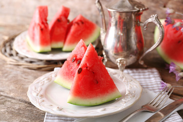 Fresh sliced watermelon on decorated wooden background