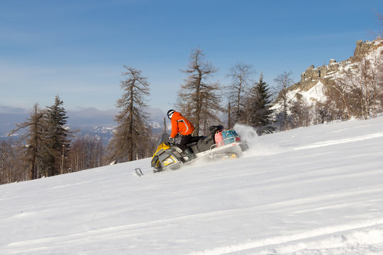 Athlete on a snowmobile.