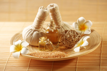 Fototapeta na wymiar Natural relaxing spa set in a bowl with sea salt on wicker background