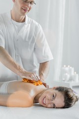 Obraz na płótnie Canvas Masseur using massage equipment