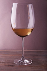 Glass of white wine on wooden table
