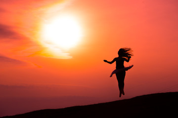 Ballerina in silhouette in a red sunset