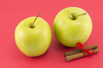 Fresh apples and cinnamon sticks with a ribbon