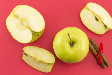 Fresh apples and cinnamon sticks with a ribbon
