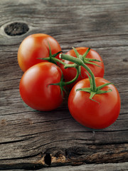 close up view of nice fresh cherry tomatoes on wooden table