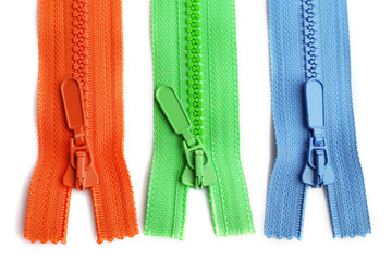 Colourful collection of zippers isolated on white, close-up