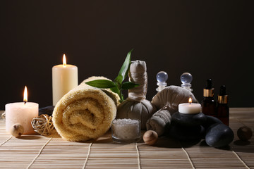 Beautiful spa set on wicker napkin on dark background