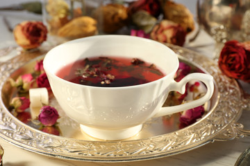 Hot rose tea on metal tray