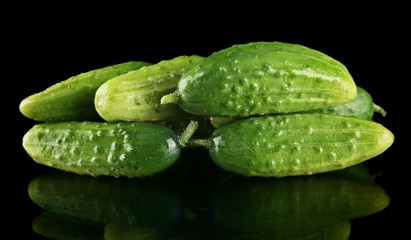 Many fresh raw gherkins isolated on black