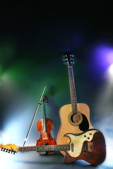 Electric and acoustic guitars, violin on dark background