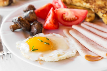 Traditional english breakfast with egg, bacon, mushrooms