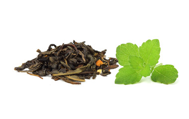 Dried leaves of green tea with a sprig of mint.