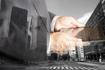 Double exposure of success businessman using digital tablet with   BUENOS AIRES ARGENTINA building...