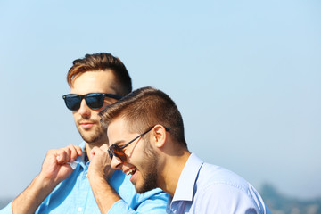 Two young men talking on the riverside