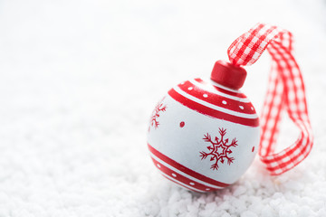 Vintage Christmas ball on snow background