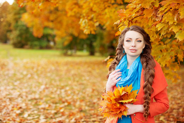 Autumn model, bright make up. woman on background fall landscape