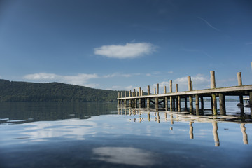 A view of a jetty in lake Windermere in the Lake District, UK