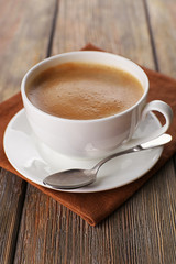 Cup of coffee on brown napkin closeup