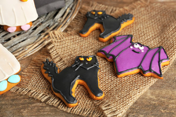 Creative cookies for Halloween party on wicker plate