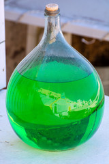 Glass bottle with green liquid