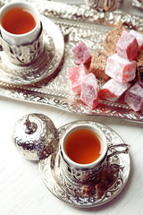 Antique tea-set with Turkish delight on table close-up