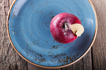 Red Apple on a blue plate.selective focus.