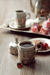 Fototapeta premium Antique tea-set with Turkish delight on table close-up