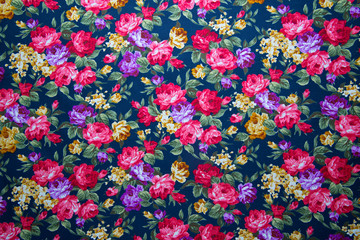 Fragment of colorful retro tapestry textile pattern with floral ornament and flowers useful as background