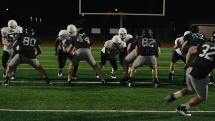 A football player gets tackled right before throwing the ball - Powered by Adobe