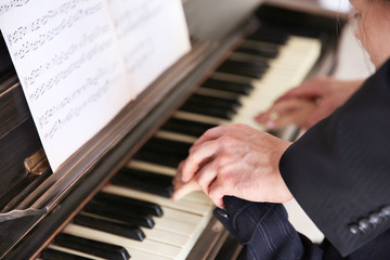 Close up of musician man and girl hands piano playing