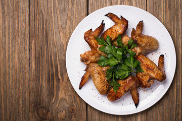 Baked chicken wings in the oven with space for text, top view