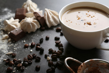 Cup of coffee and sweets on black wooden background