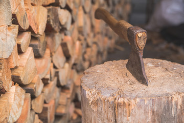 Hatchet thrusted in old stump.