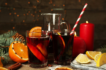 Decorated composition of mulled wine in glasses on wooden table