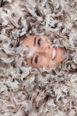 Fototapeta premium girl looking out of feathers