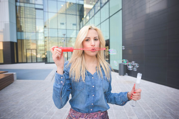 Young beautiful caucasian blonde girl in the city