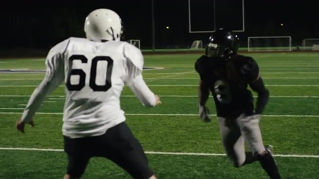 A football player catches a pass and makes a touchdown in slow motion
