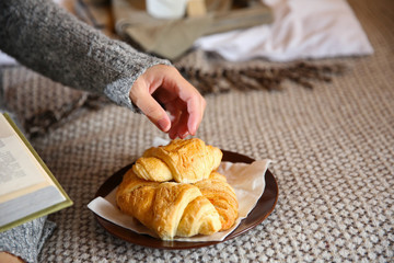 Girl with light breakfast on bed