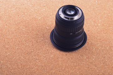 Camera photo lens over brown background